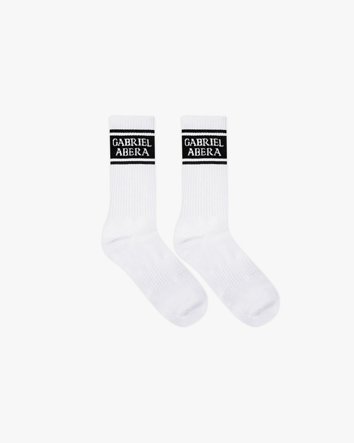 A pair of white socks with black section and brand