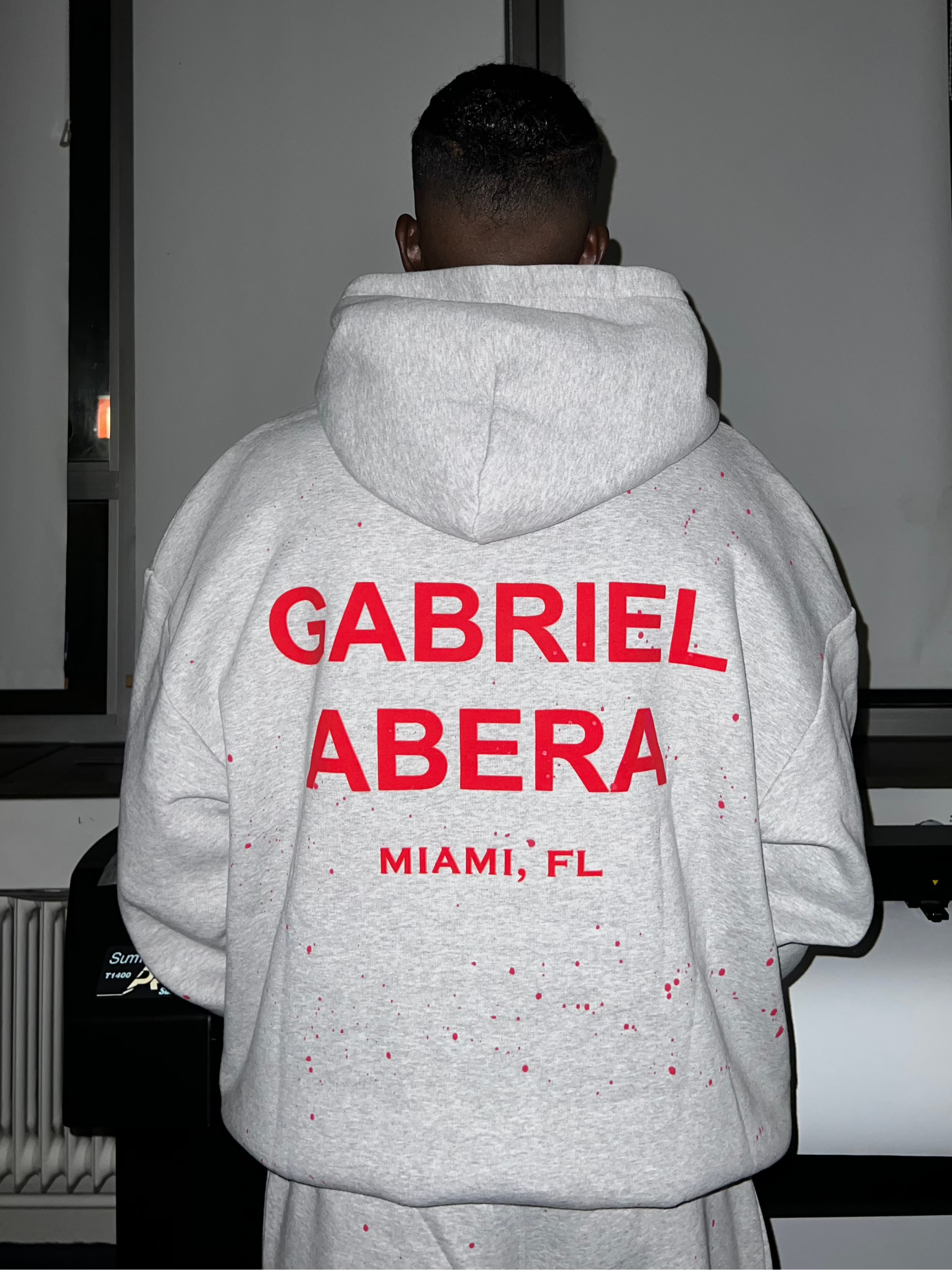 Back view of Oversized Splattered Hoodie in Grey with puff print and bold artistic streetwear vibe.